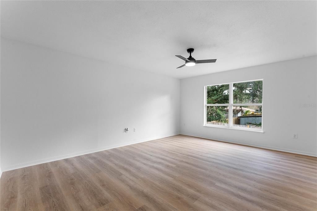 Primary bedroom with large windows.