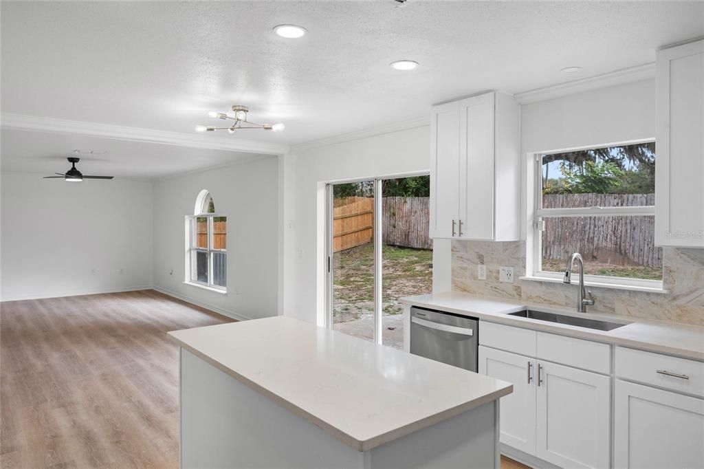 Kitchen opens up to large living room