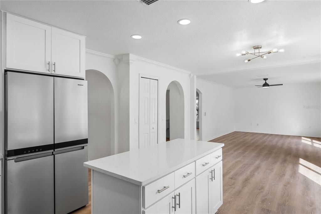 Kitchen with island with storage, new refrigerator and beautiful crown molding