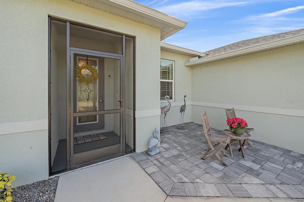 screened front entry and sweet patio