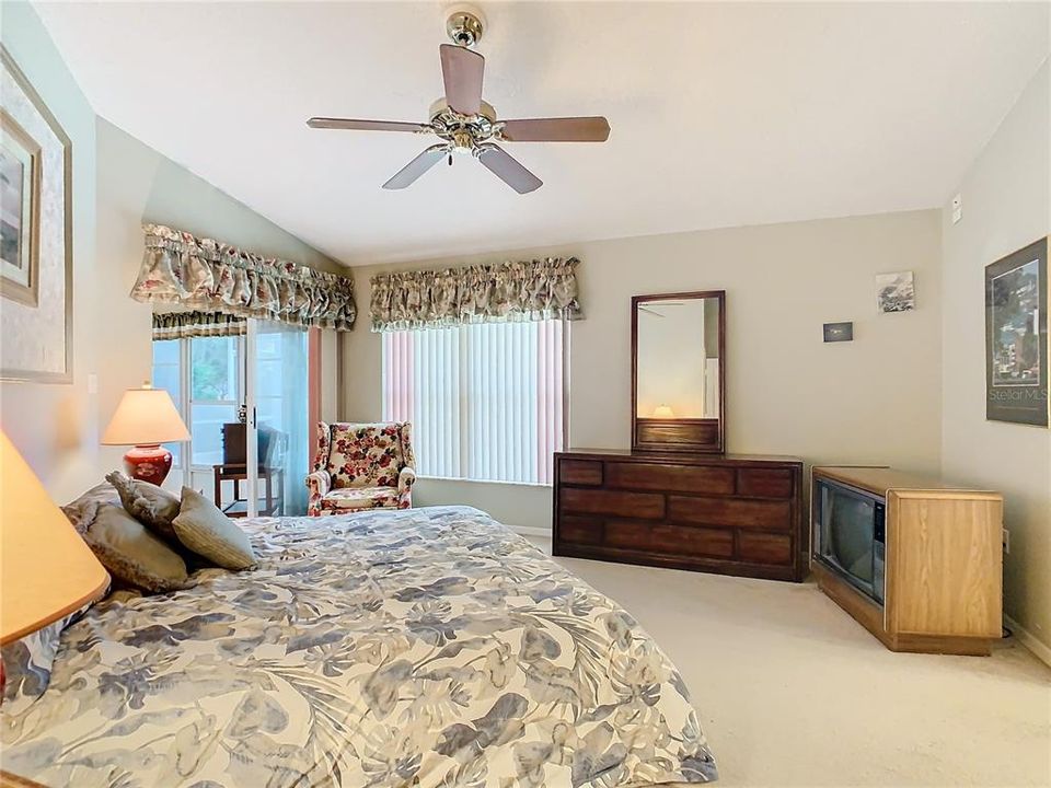 Primary bedroom has a sliding glass door that opens to the enclosed Florida Room.