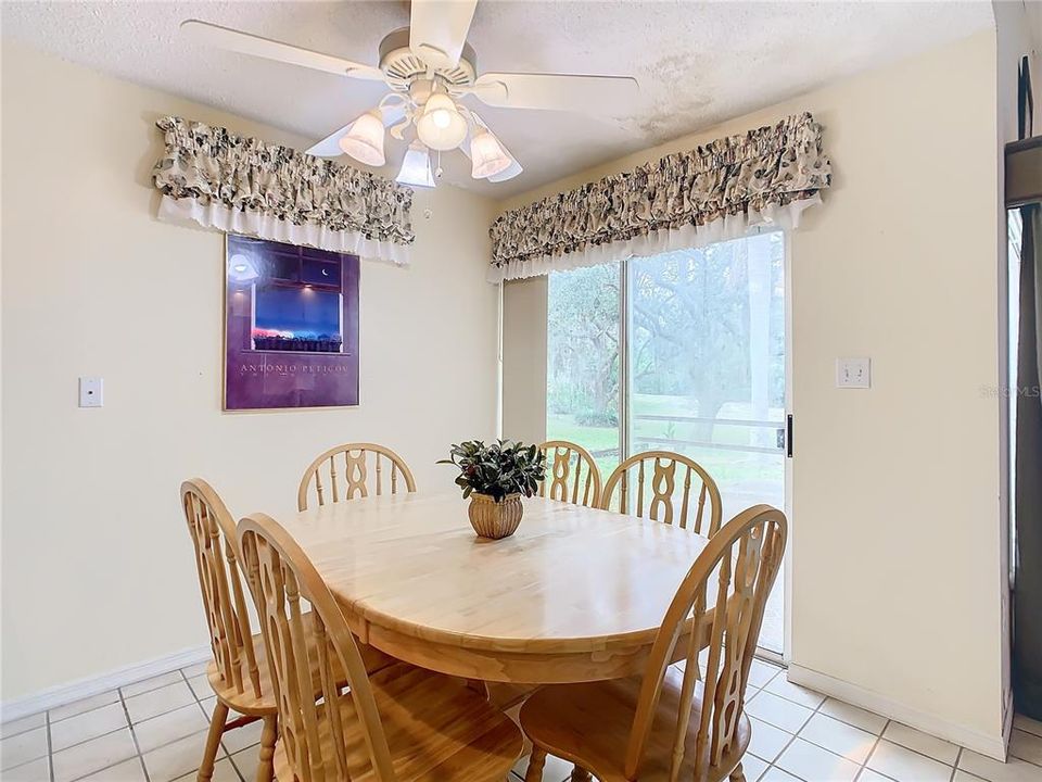 The dining room has a sliding glass door that opens to the side patio