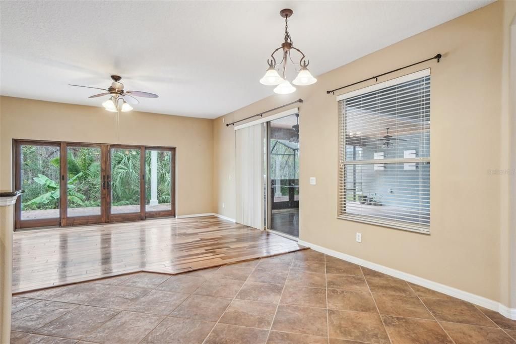 Family room with hardwood floors and doors out to the paved patio with pergola