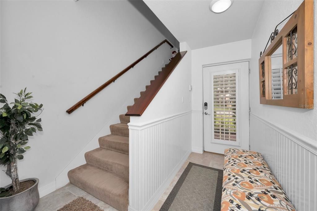 Welcoming Foyer wool carpet & Mahogany banisters