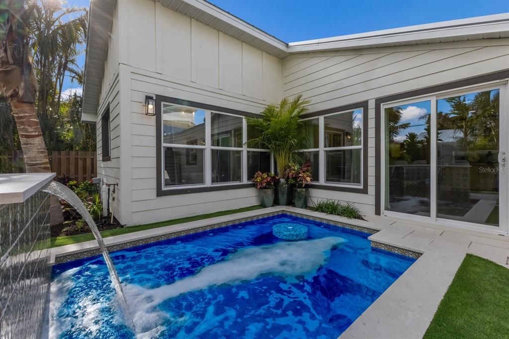 Heated saltwater pool w/ waterfall and cocktail table