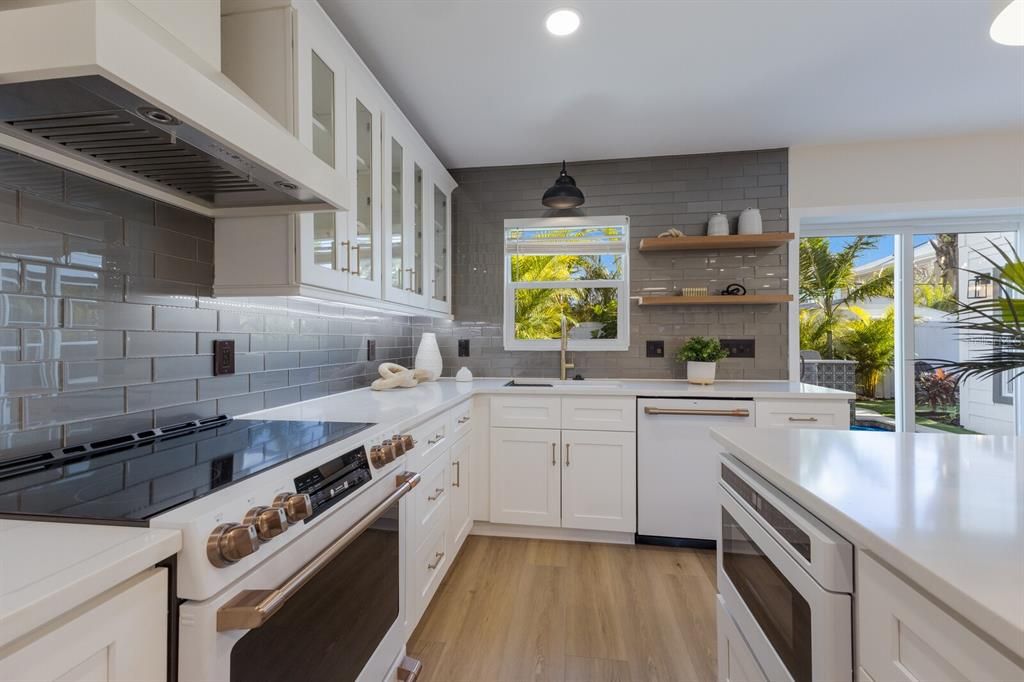 Under lighting, beautiful tile backsplash and large farm sink