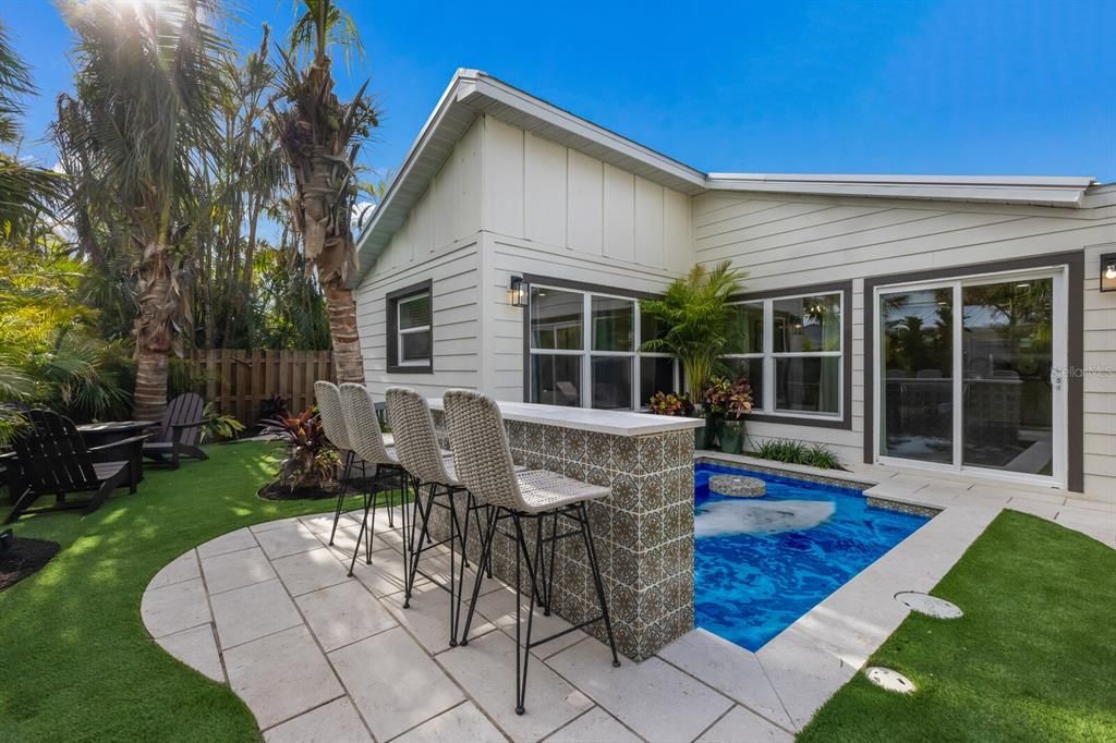 Sandstone pavers surround the pool