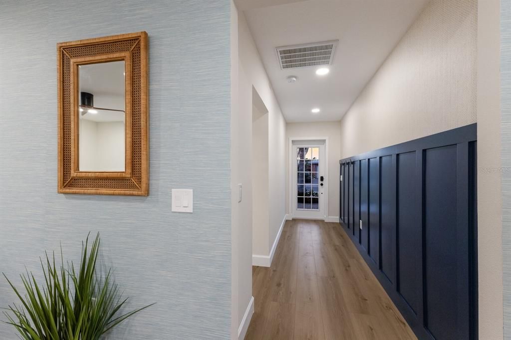 Entry hall with custom woodwork and Serena and Lily wallpaper