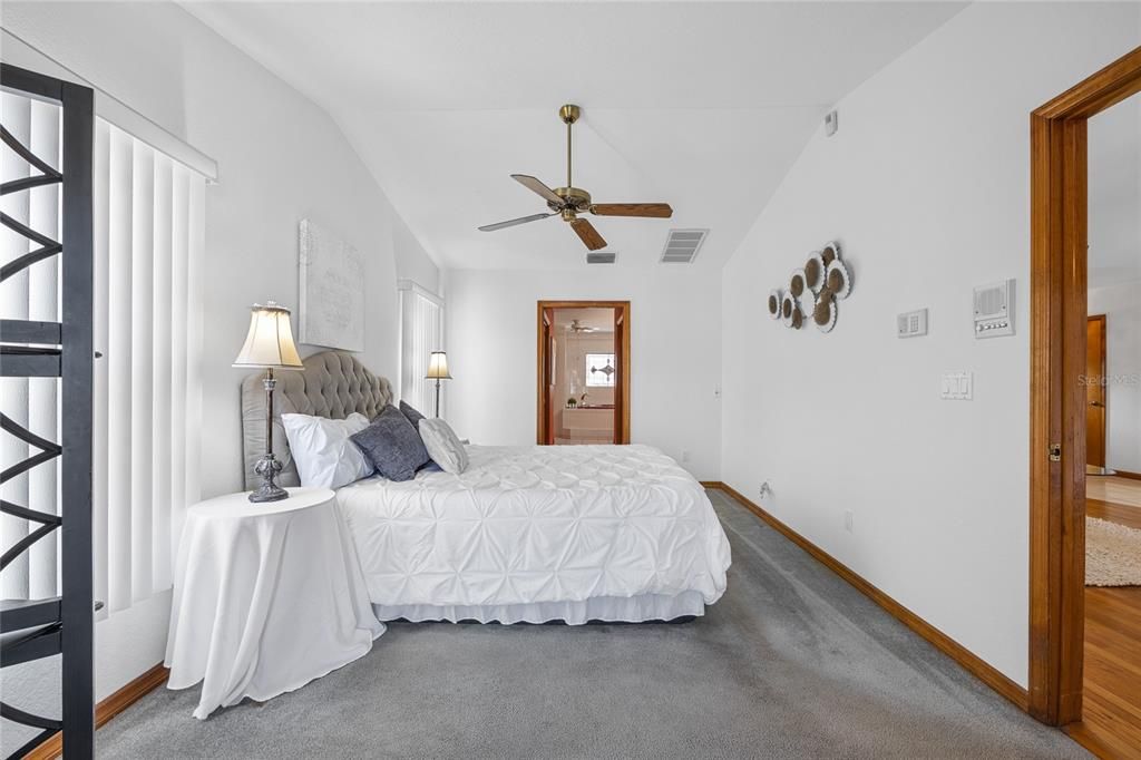 The primary bedroom has vaulted ceilings, dual walk in closets and a large ensuite bathroom