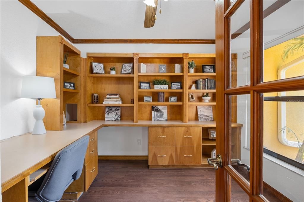 This office/library at the front of the home has a built in desk and lots of bookcases