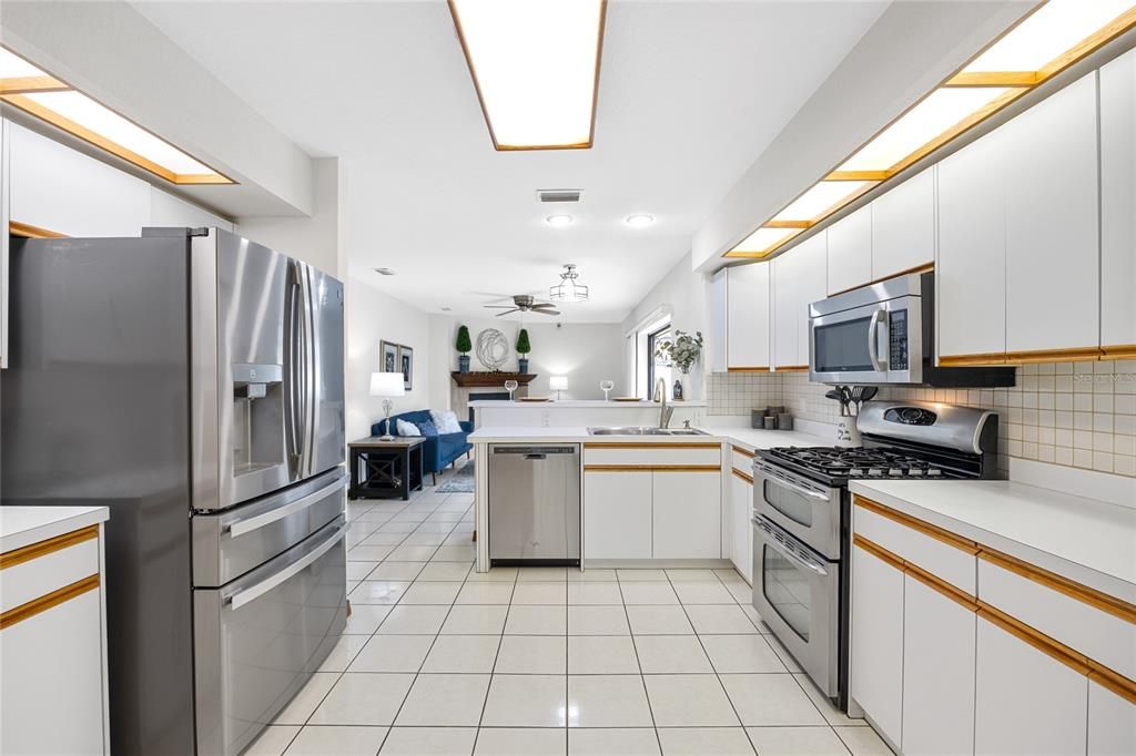 The kitchen overlooks the family room and has a natural gas range and breakfast bar for quick meals.