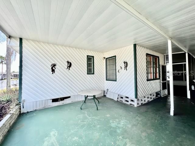 Wide covered carport & porch.