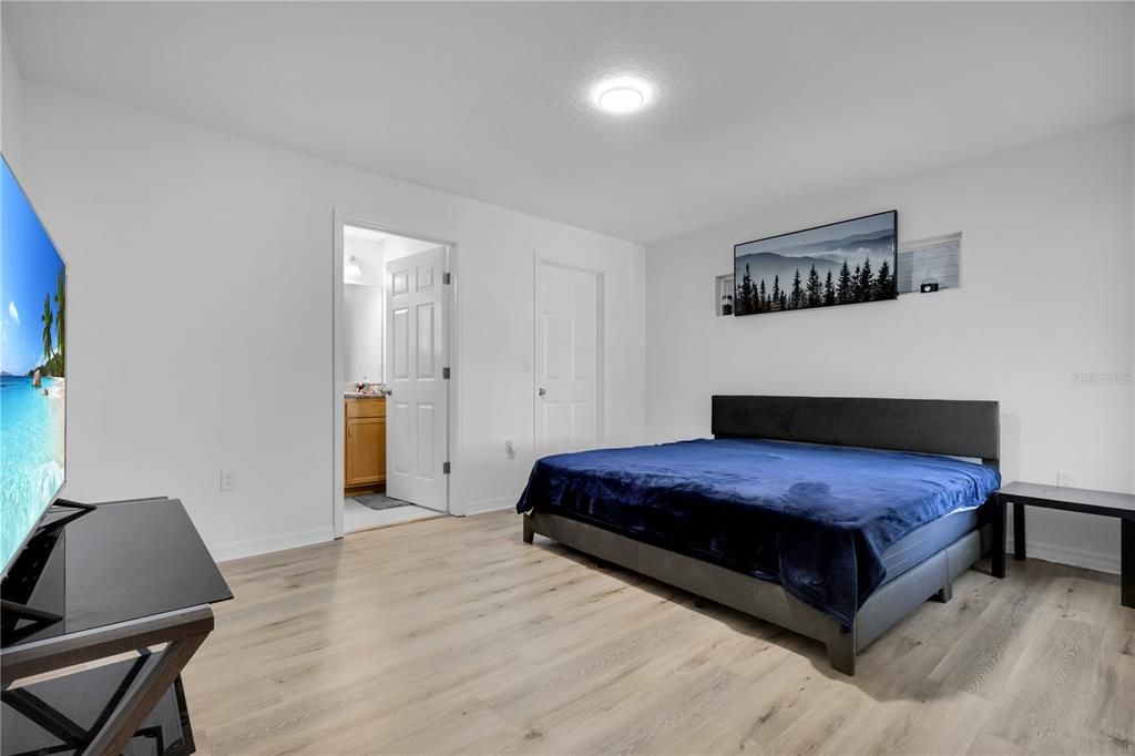 Primary bedroom in Unit A with a spacious walk in closet and in suite bathroom