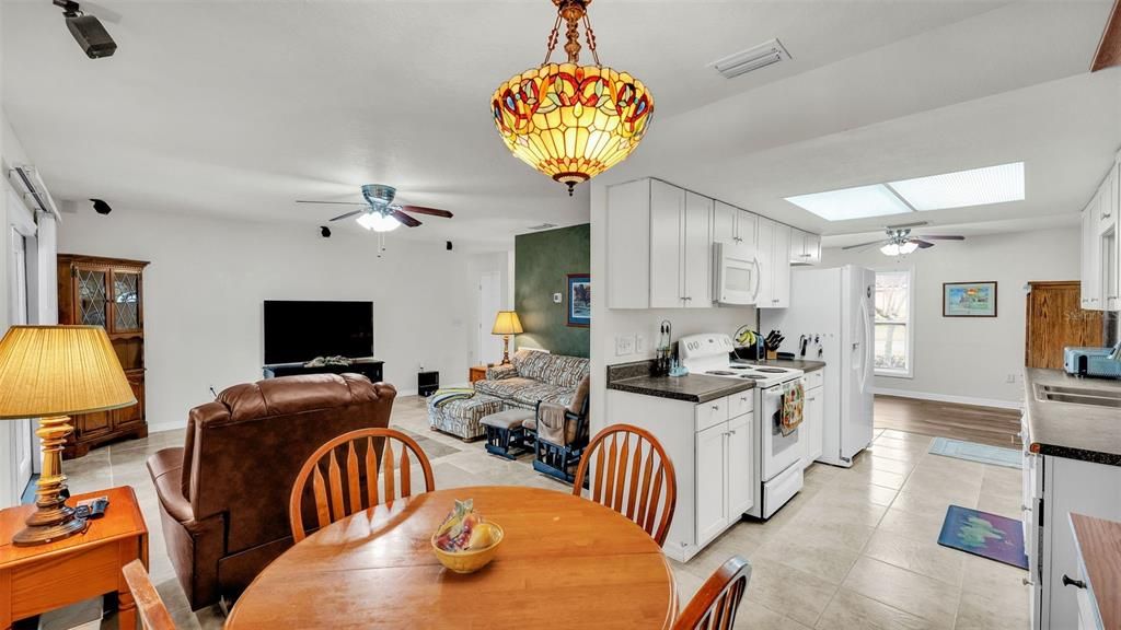 Eat-in breakfast nook looking into kitchen and formal living room