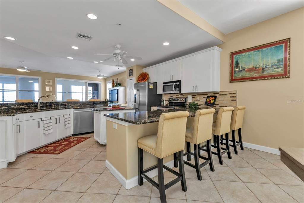 Spacious kitchen with eat-in bars on both sides.