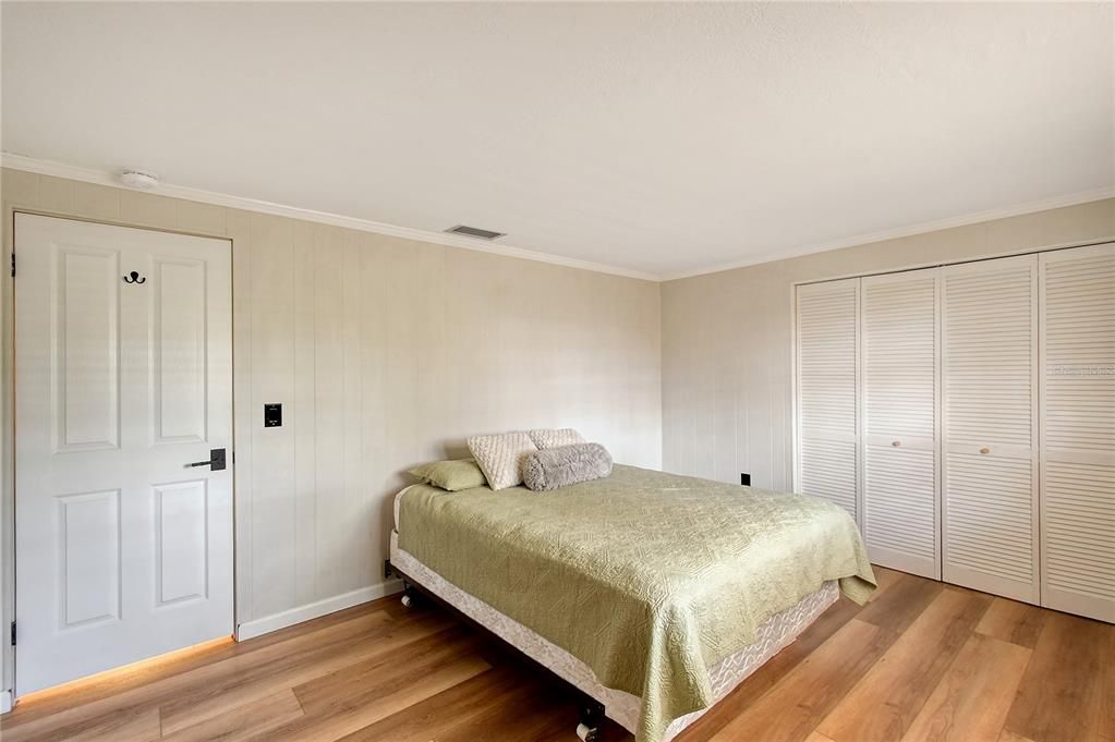 Bedroom #3  Luxury Vinyl Plank Flooring, Double Wide Closet, Walls are Painted Paneling