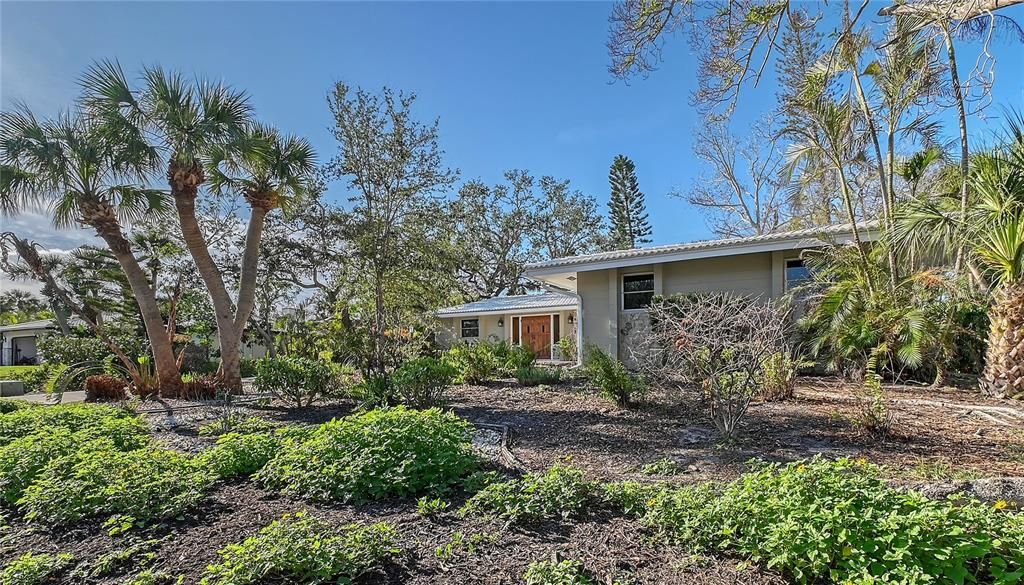 Front Street View - Front Yard Maintained as Florida Green Landscape.  Home is elevated 9'-7"