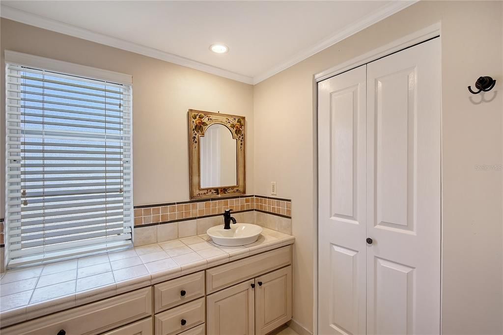 Primary Bathroom Ensuite, All Wood Cabinetry, Linen Closet, Tile Countertop and Flooring