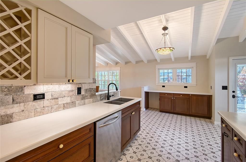 Kitchen with All Wood Cabinetry, Corian Solid Surface Countertops, Deep Stainless Steel Double Bowl Sink, Stainless Steel Appliances, Pot Drawers, Wine Rack