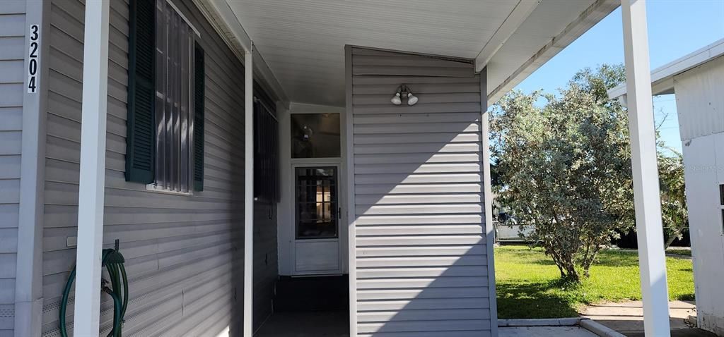 Front Entry into your slice of Paradise.....built in storage shed to right of entry door....