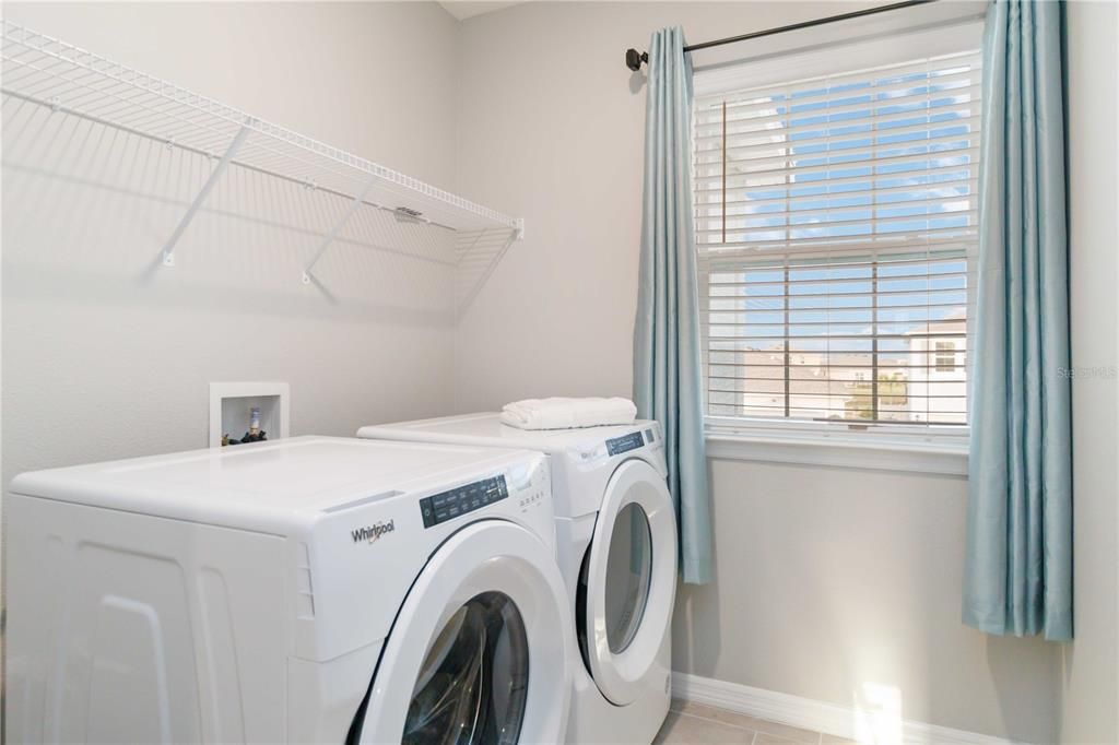 Upstairs laundry with upgraded washer and dryer.