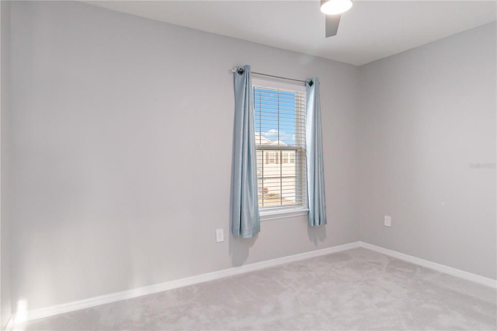 Bedroom 4/4 overlooking street view with large closet.