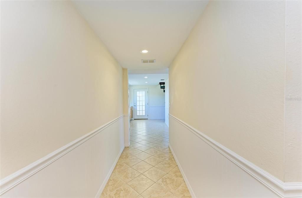 First floor hallway leads to kitchenette & Primary Master Bedroom #1