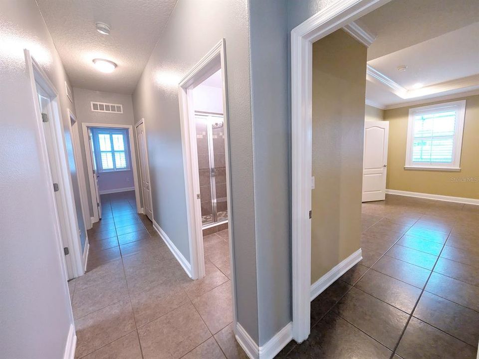 Hallway looking into master and third bathroom