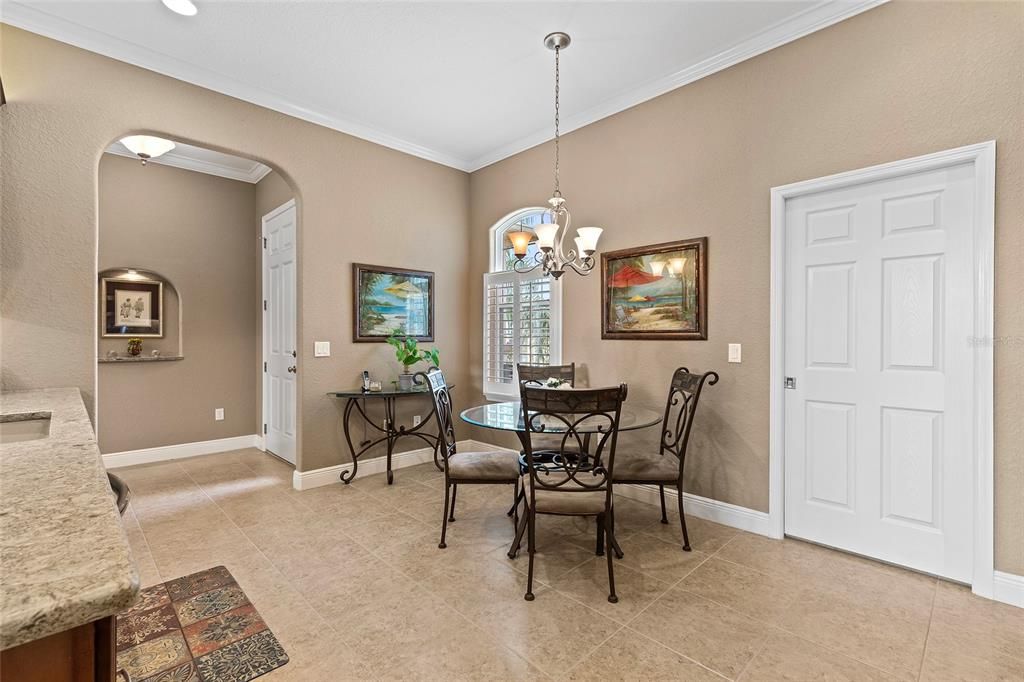 Eat-in area in kitchen. Closed pocket door to right lead to laundry room and garage