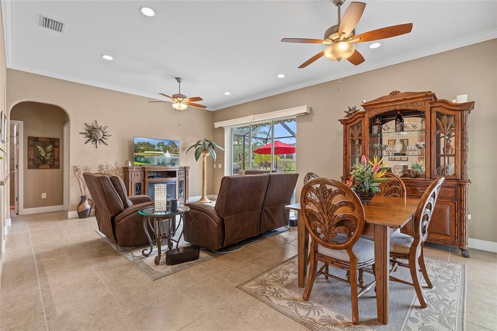 Living room/Dining room with tile, crown molding, 5.25" baseboards