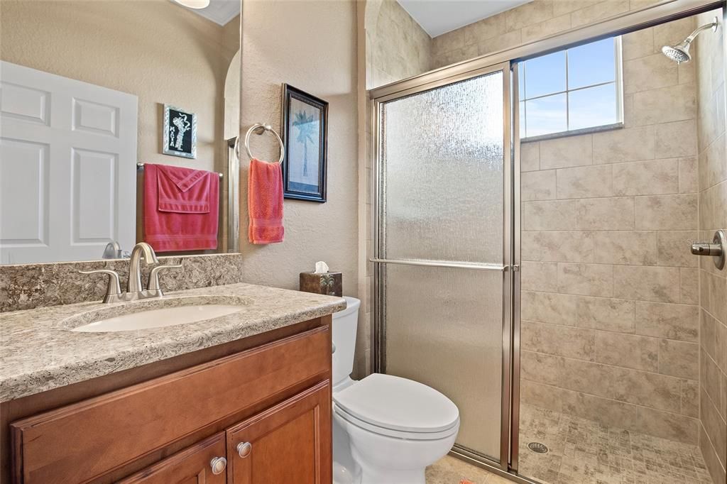 Guest bath with Quartz countertop, Tiled walk-in shower