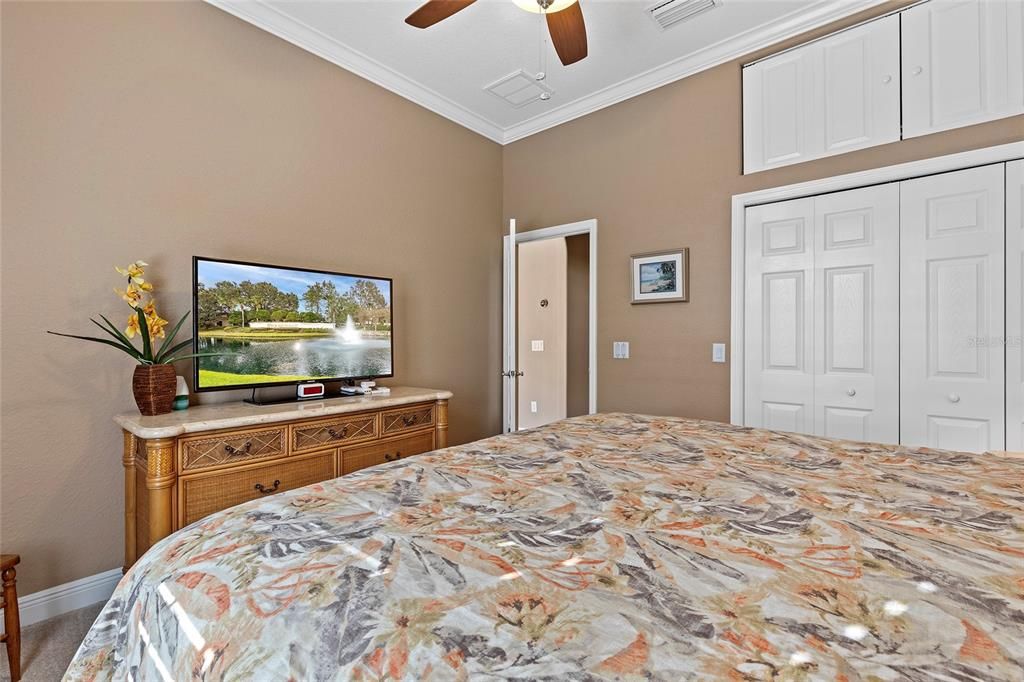 Guest bedroom with additional storage above closet