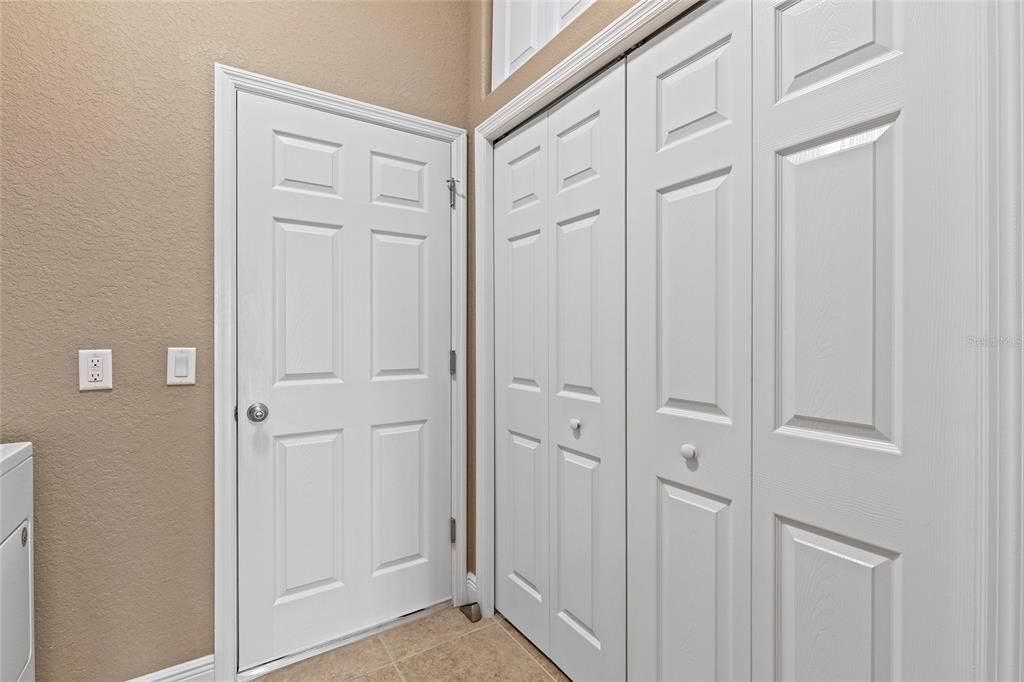 Large pantry in laundry room with overhead storage