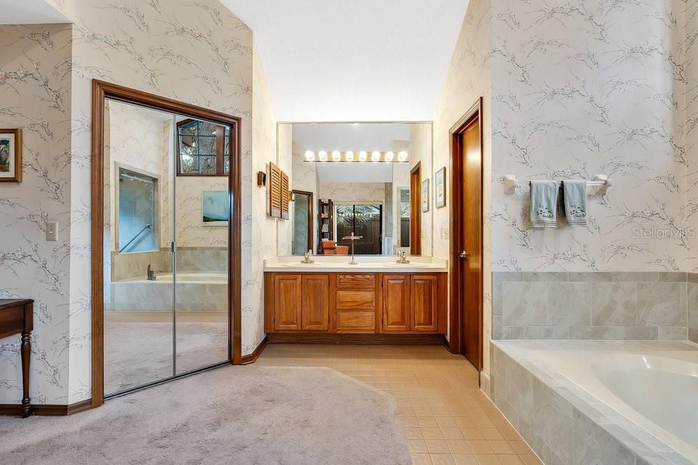 Primary Bathroom with 1 of the Walk-In Closets