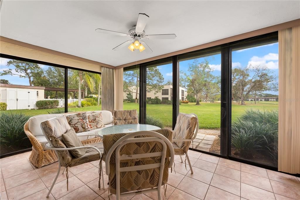 Covered Lanai with views of the golf course and the pool.