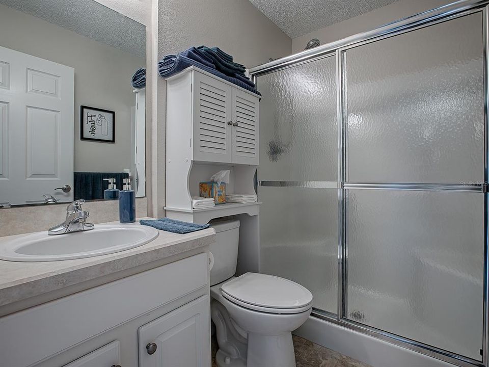 THIS LOVELY BATH HAS A WALK-IN SHOWER WITH BUILT-IN BENCH SEAT