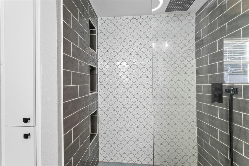 Beautiful porcelain tile work in the primary walk-in-shower