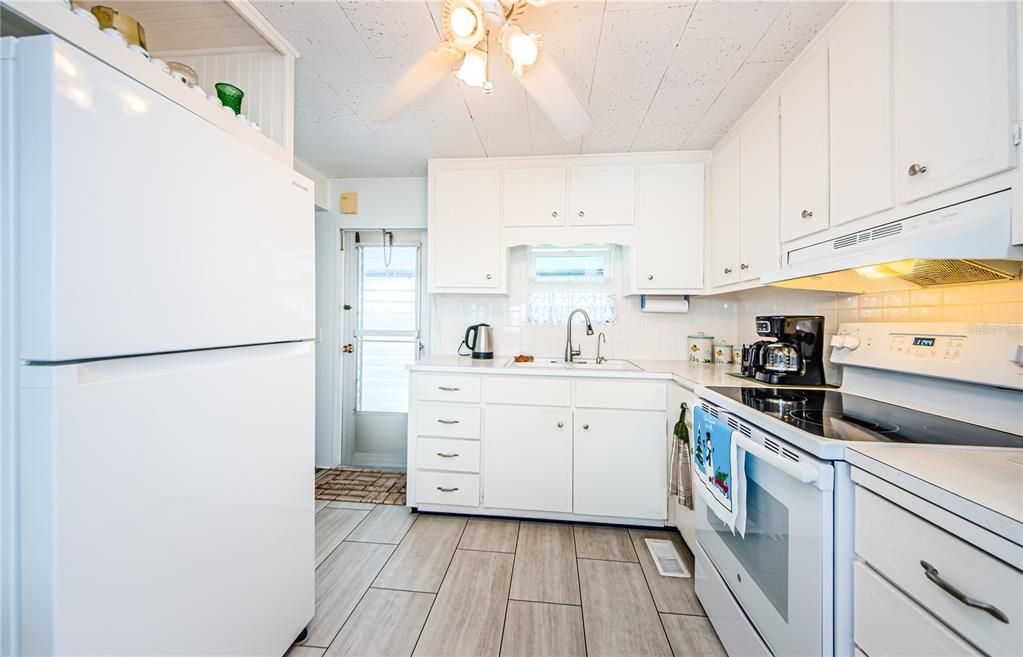 Kitchen with newer updated appliances and 2nd exterior entry