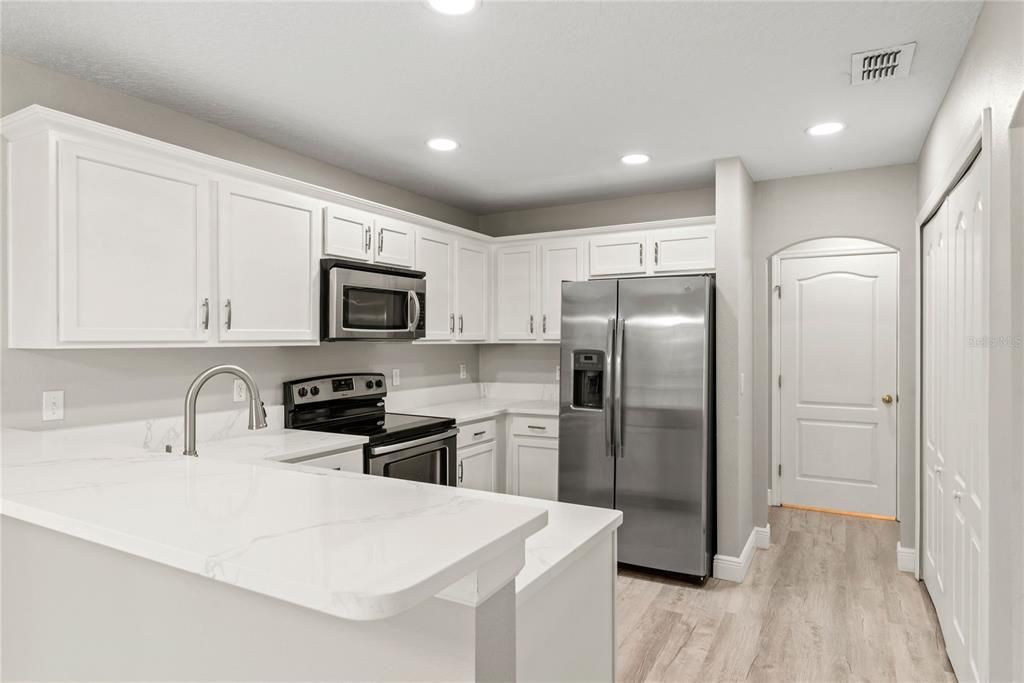 Fully remodeled kitchen features quartz countertop and stainless steel appliances