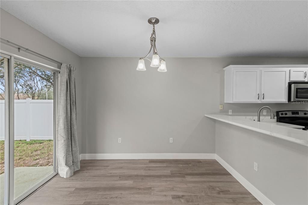 Eat-In kitchen with sliding doors that lead to patio and back yard