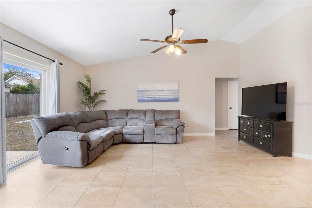 large family room with triple sliding glass doors