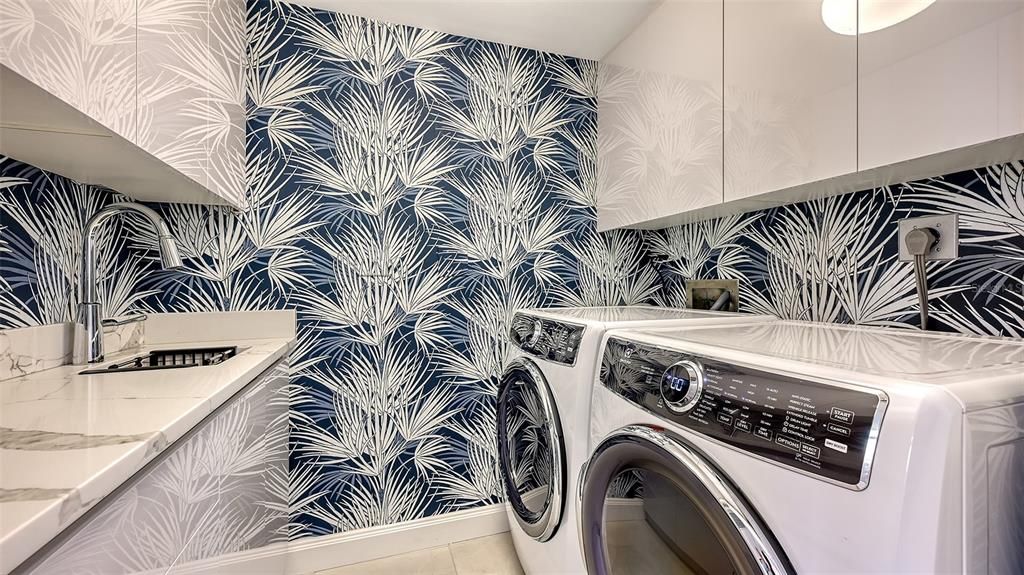 Beautifully appointed laundry room w/ custom cabinetry