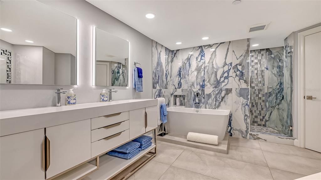 The azure stone tile creates a spa like atmosphere in the soaking tub or walk in shower, separate WC