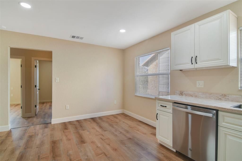 Kitchen with hallway to two additional spaces and laundry room