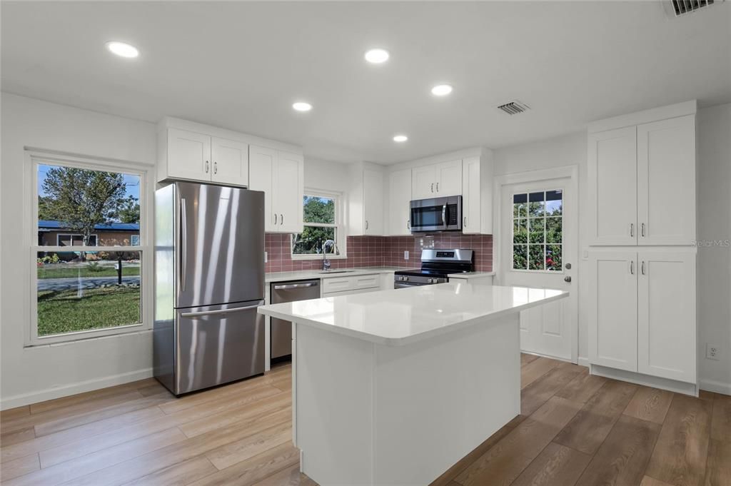 Beautiful new kitchen with designer tile backsplash