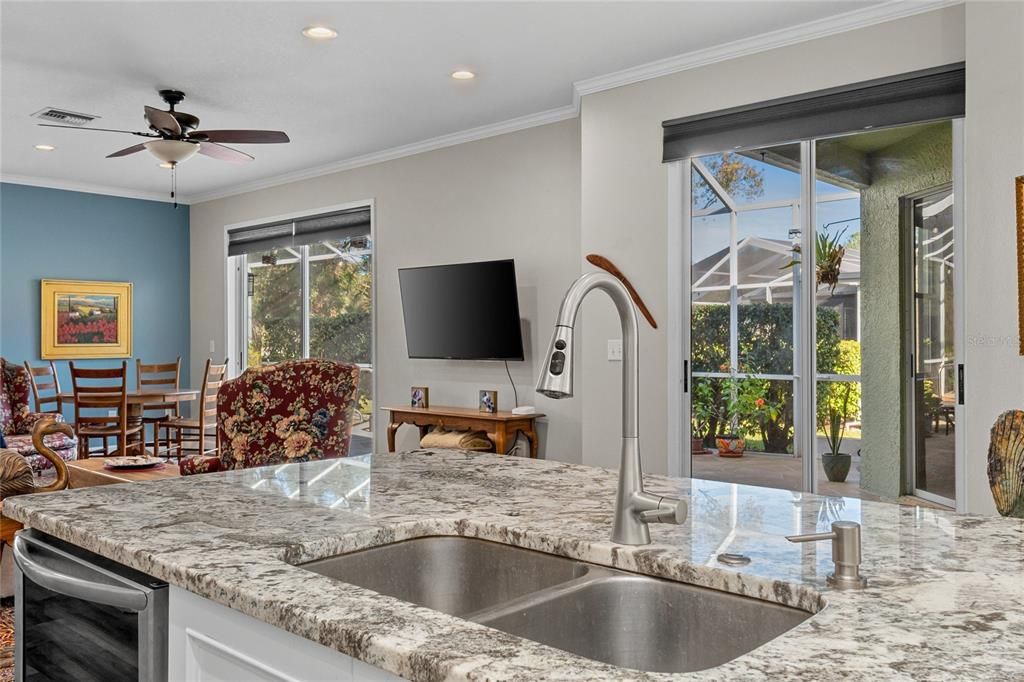 Open floorplan, Kitchen & Family room combo with sliders to the Screened in Pool area.