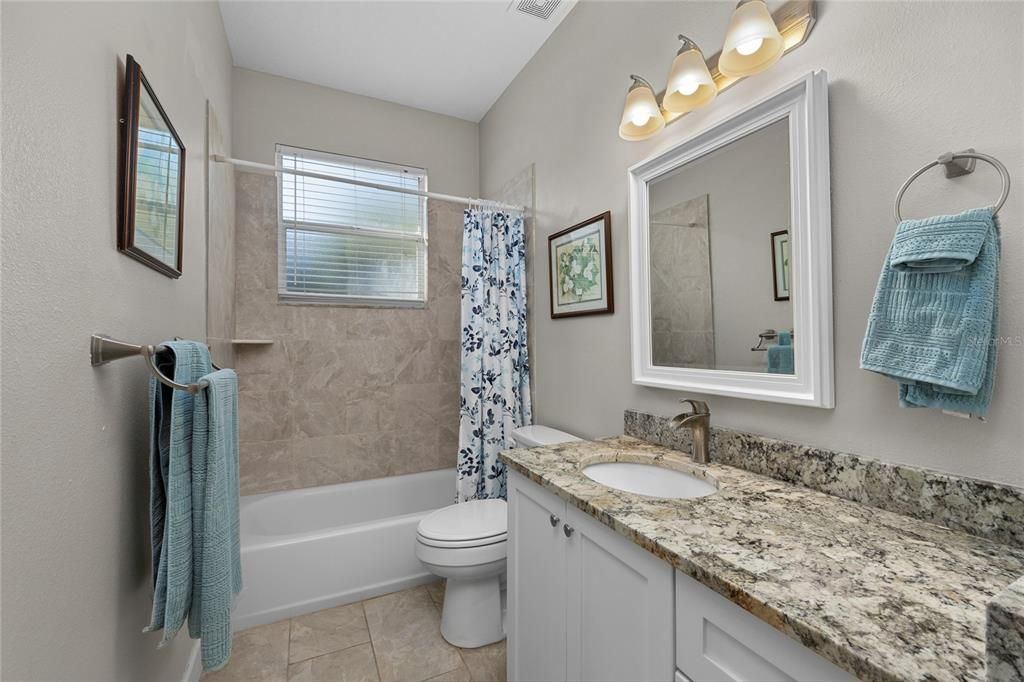 Bathroom 2 is fully updated with granite countertops, brushed nickel fixtures and neutral tile throughout