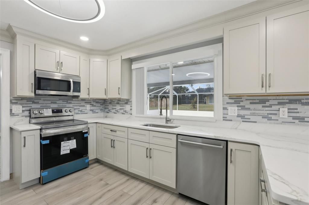 Kitchen features Stainless Premium Appliances and Stile stone Counter tops.