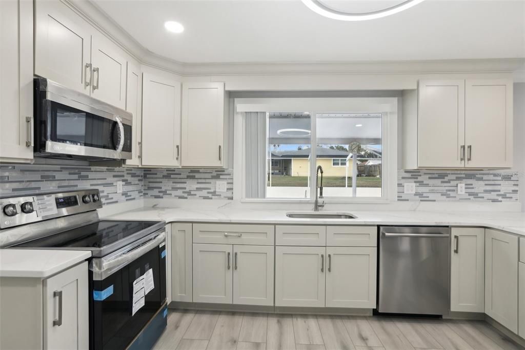 Kitchen has sliding window to pool area to make serving easy with service counter.