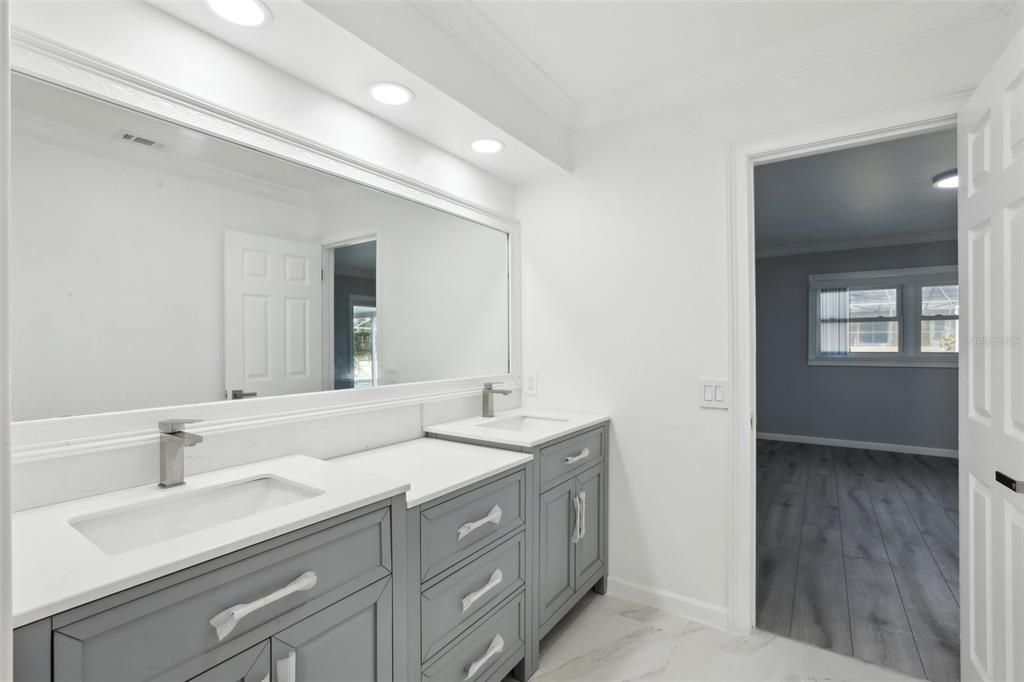 Primary bath with double vanities and double sinks.